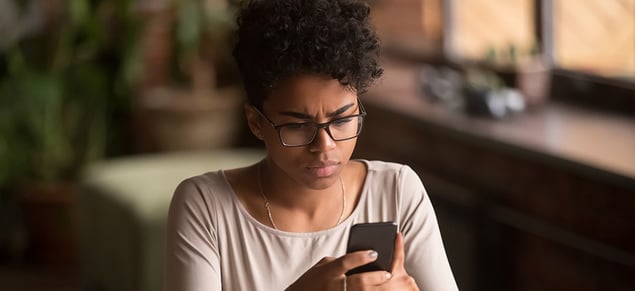 Confused Woman Looking at Phone_GettyImages_980x450