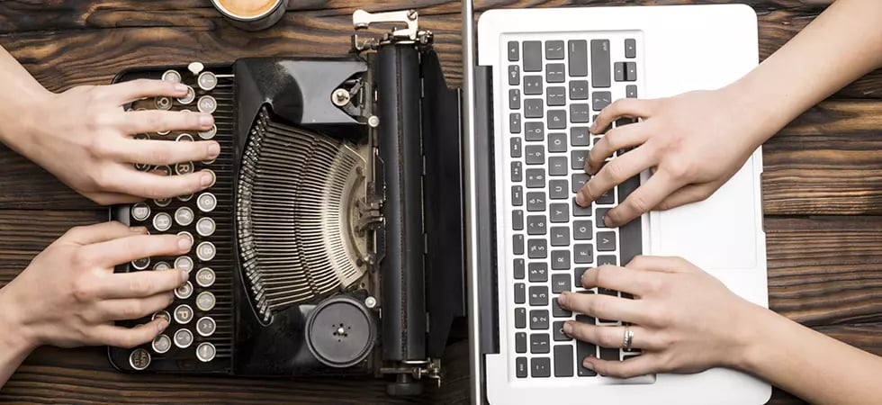 GettyImages-1281115764-Old Typewriter and Laptop in Use_980x450