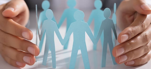 GettyImages_hands around blue paper cut out people_980x450