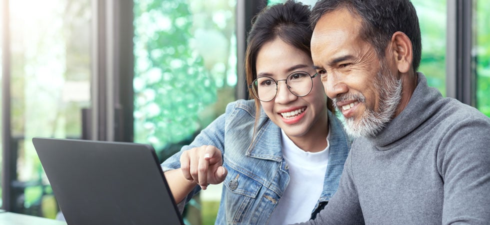 Father and daughter on computer together