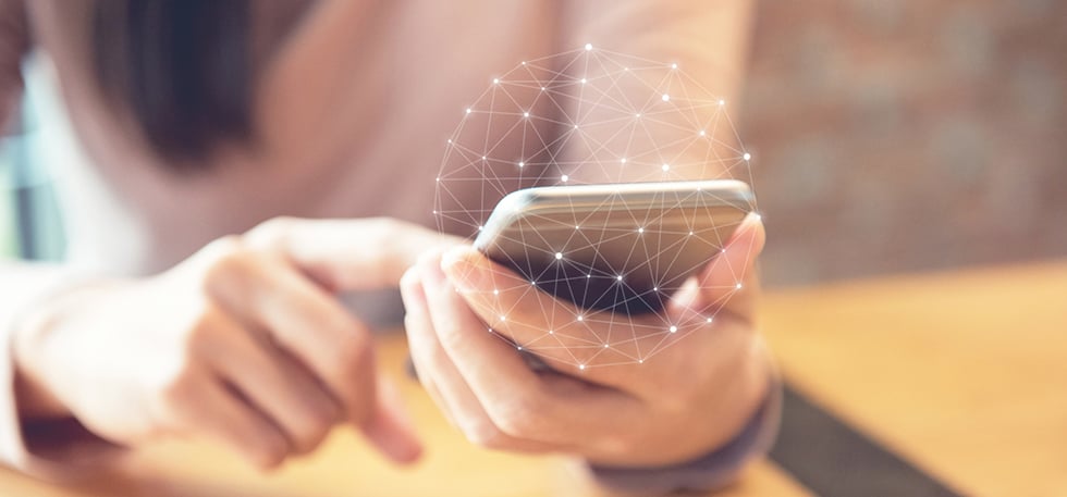 Woman's hands holding a smartphone with a grid overlay