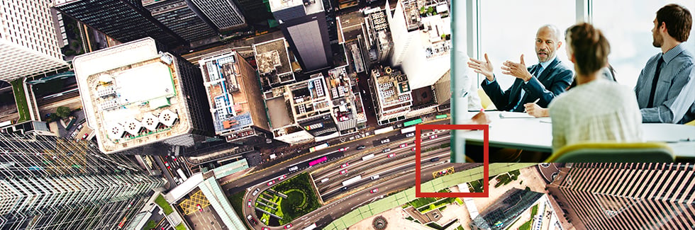 Arial shot of a city with an overlay image of 4 business colleagues chatting