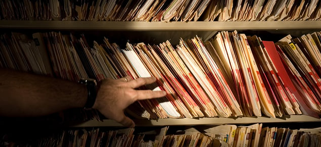 Man Hand with Flashlight looking at Medical Records_GettyImages_980x450