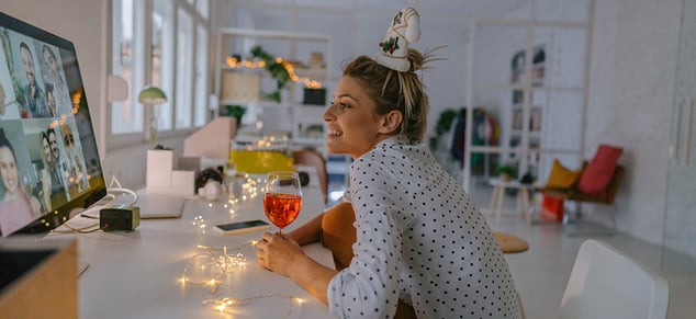 Woman Drinking Wine During Virtual Holiday Party_GettyImages_980x450