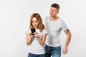 highly staged stock photo of shoulder surfing (1)